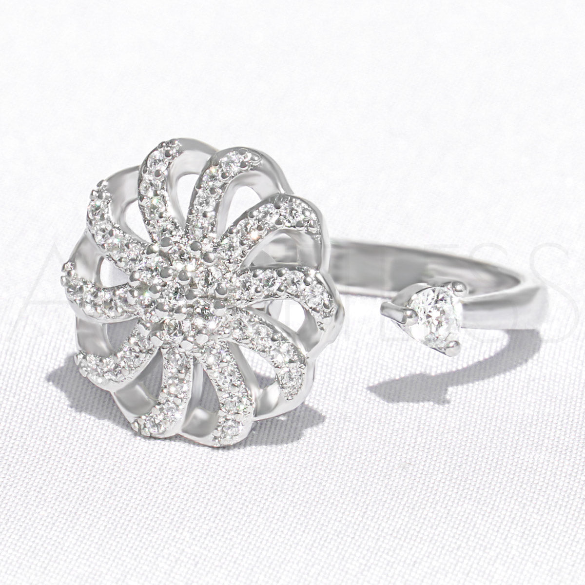 Silver flower fidget ring, spinner ring, against a white background