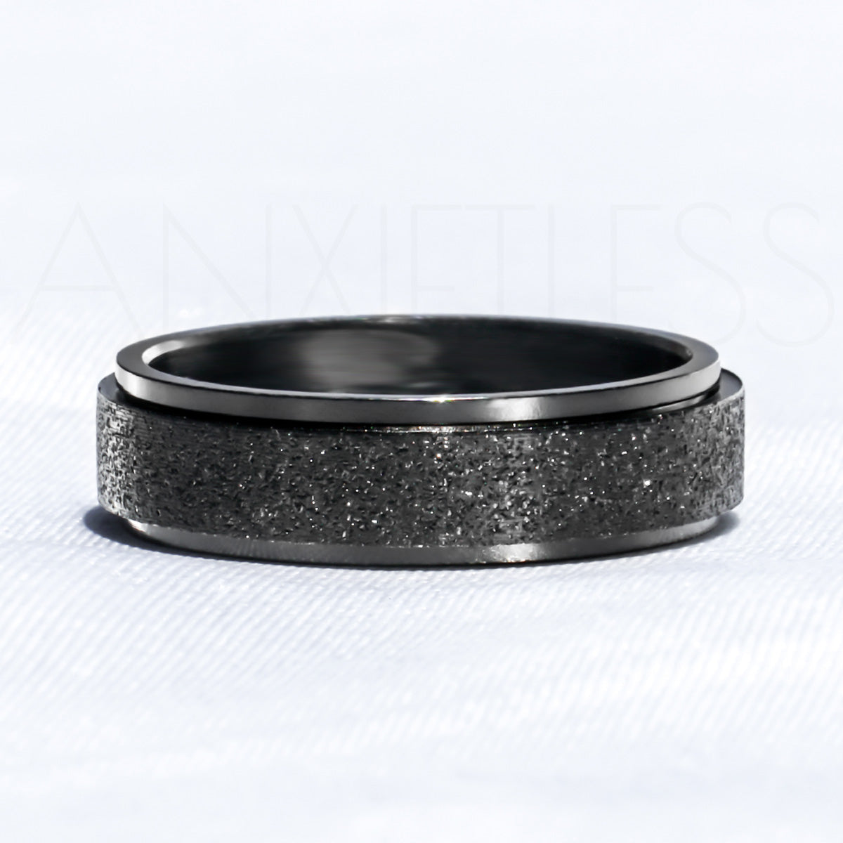 Sparkly Black Anxiety Ring Laid Flat on White Background
